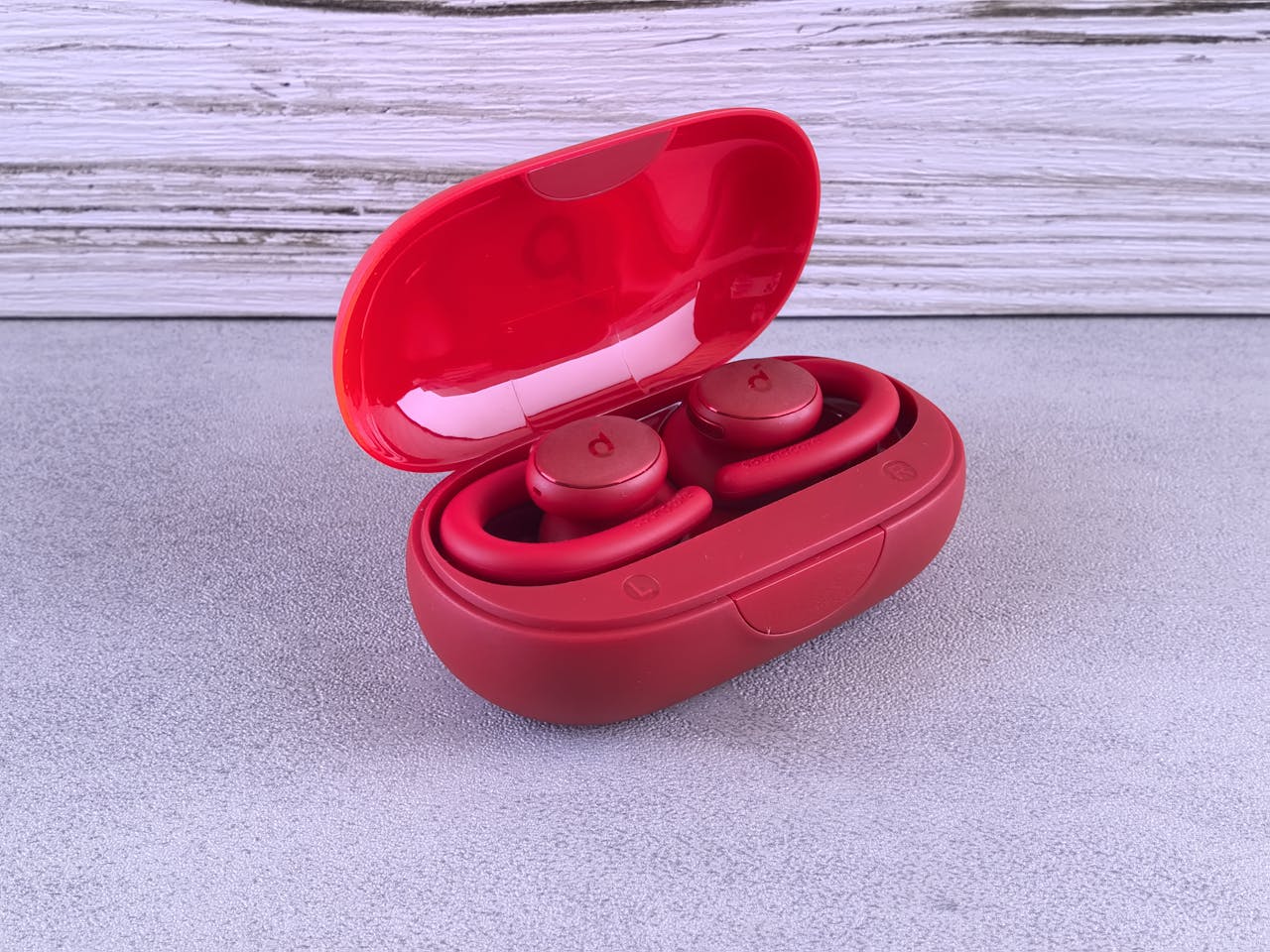 services-01 Vibrant red wireless earbuds in a sleek charging case on a modern background.